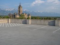 several large empty parking spaces in the city with buildings nearby in front of them -