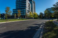 city streets with a building and many trees in front of it at daytime with blue sky