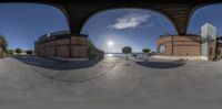 some fisheyes looking in while someone rides their skate board on a ramp and another is doing a trick