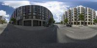 the 360 - lens image shows two streets and a building that appears to be in motion