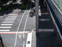 a parking space with bikes on it and pedestrian crossing for pedestrians to ride up and down the street