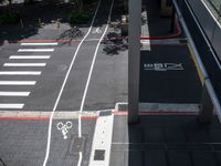 a parking space with bikes on it and pedestrian crossing for pedestrians to ride up and down the street