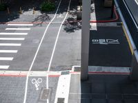 a parking space with bikes on it and pedestrian crossing for pedestrians to ride up and down the street