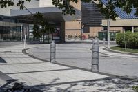 a person sitting at the bench in front of a mall that is empty of people