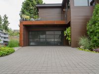 there is an outside view of a house with brown exterior and wooden building, plants around the entrance area and trees