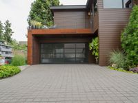 there is an outside view of a house with brown exterior and wooden building, plants around the entrance area and trees