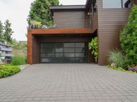 there is an outside view of a house with brown exterior and wooden building, plants around the entrance area and trees