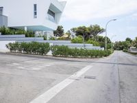 a modern villa with an outdoor living space and garden with views overlooking the sea and mountains