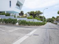 a modern villa with an outdoor living space and garden with views overlooking the sea and mountains