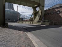 a view of a walkway crossing a bridge that runs over the road and there is a bus going underneath