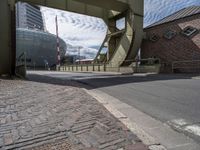 a view of a walkway crossing a bridge that runs over the road and there is a bus going underneath