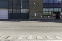 an empty parking lot with building in the background that reads warehouse - no cars required