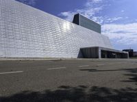 a large, modern white building with metal and glass facade, which is the most prominent symbol