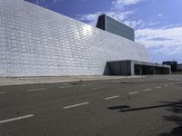 a large, modern white building with metal and glass facade, which is the most prominent symbol