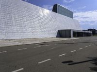 a large, modern white building with metal and glass facade, which is the most prominent symbol