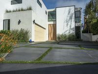 the front of a white two story house in the suburbs of los angeles with a sidewalk between two cars and an outdoor driveway