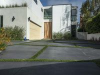 the front of a white two story house in the suburbs of los angeles with a sidewalk between two cars and an outdoor driveway