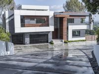 modern white residence in the city on a cloudy day near the hills with a paved driveway