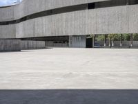 two people are walking on a skateboard in an empty building with two parking meters in the foreground