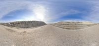 a desert area with a big desert on the left and a road on the right