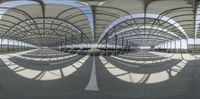 an outdoor area in the shape of a circle, with some shade, outside a train station