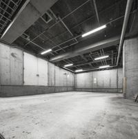 there is a big warehouse with cement walls and large beams in it for concrete walls