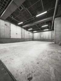 there is a big warehouse with cement walls and large beams in it for concrete walls