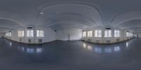 a fish eye view of an empty white room with windows and floors and ceilinging