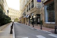 a paved city street surrounded by buildings and bushes in europes middle east side area