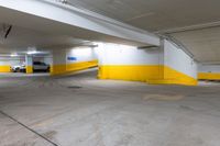 the car park has yellow and white painted flooring and a blue sign that reads sorren