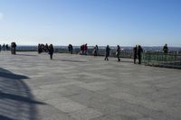 a group of people that are on a roof top with a kite in the sky