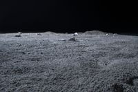 rocks sit alone on top of some grass on the surface of space, lit by spotlight from bright spotlights