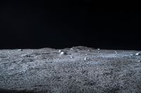 a photo of an object on the moon with other objects and pieces of equipment on the ground