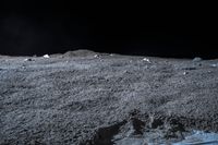 a photo of an object on the moon with other objects and pieces of equipment on the ground