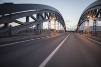 the view of two lanes and the bridge, from behind them on a vehicle's driving