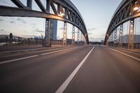 the view of two lanes and the bridge, from behind them on a vehicle's driving