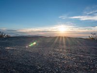 the sun shines on an empty rocky road in iceland, where the beach is next to the water