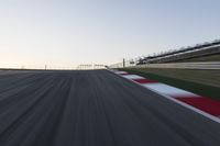 a speed track with motion bluring across it at dusk, with a blue sky