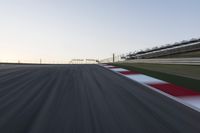 a speed track with motion bluring across it at dusk, with a blue sky