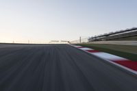 a speed track with motion bluring across it at dusk, with a blue sky