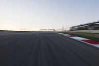 a speed track with motion bluring across it at dusk, with a blue sky