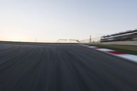 a speed track with motion bluring across it at dusk, with a blue sky