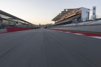 a racing track with the start in motion of it at dusk, motion blurry