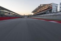 a racing track with the start in motion of it at dusk, motion blurry