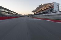 a racing track with the start in motion of it at dusk, motion blurry