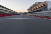 a racing track with the start in motion of it at dusk, motion blurry