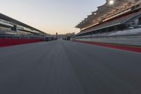 a racing track with the start in motion of it at dusk, motion blurry