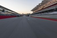 a racing track with the start in motion of it at dusk, motion blurry