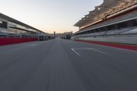 a racing track with the start in motion of it at dusk, motion blurry