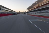 a racing track with the start in motion of it at dusk, motion blurry